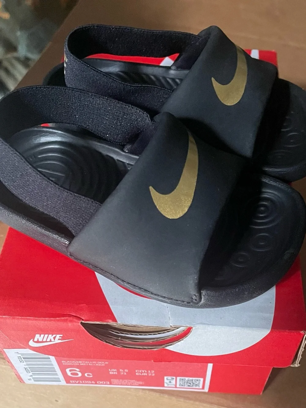 Nike Kids Black Slides with Gold Swoosh Accent